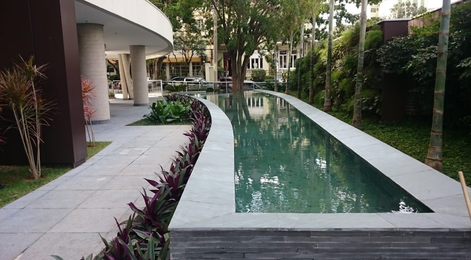 Acesso ao edifício do escritório da Concepção Arquitetura, com espelho d'água e paisagismo